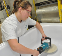 skilled worker polishing bathtub