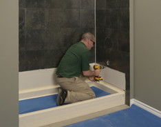 Bath Fitter installer working on wall repair