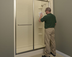 Bath Fitter installer working on shower door installation